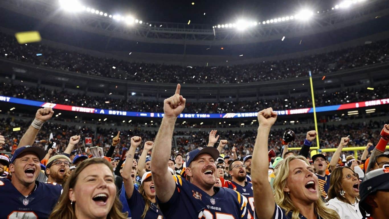 Super Bowl crowd cheering under stadium lights with confetti.
